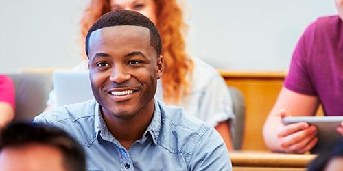 young african american guest student sitting in class
